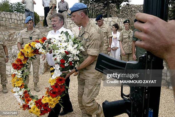 Belgian Defence Minister Andre Flahaut lays a wreath at the memorial statue of three Belgian UN soldiers who were killed in a car accident in...