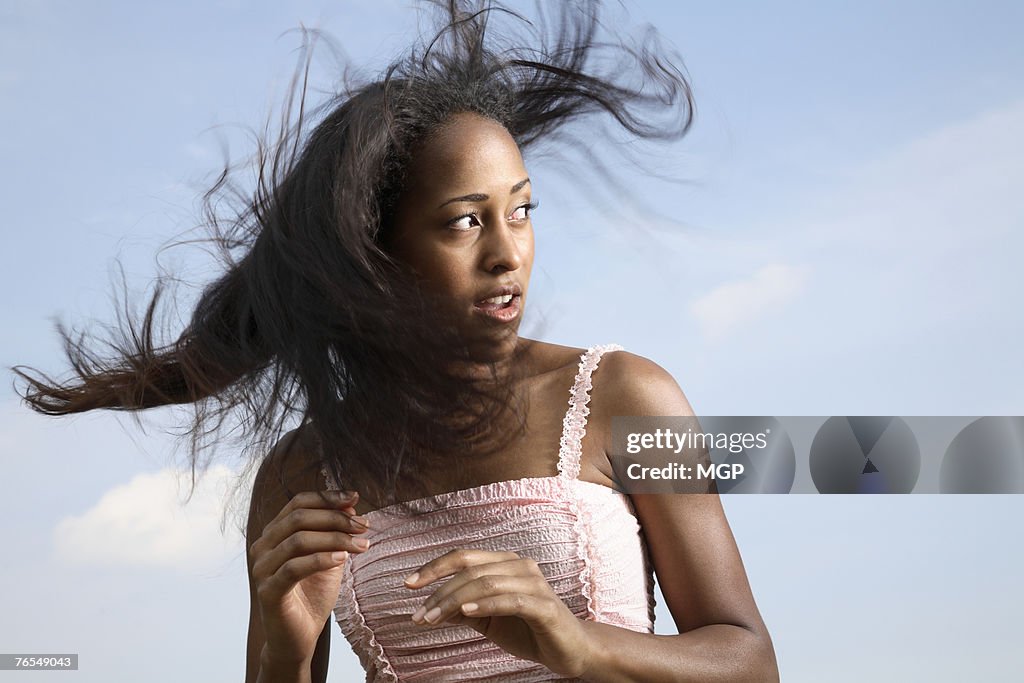 Young woman outdoors, turning head