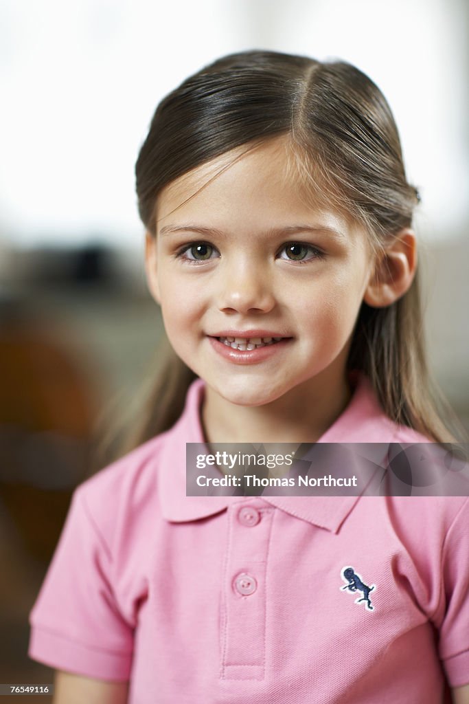 Girl (4-6) smiling, portrait, close-up