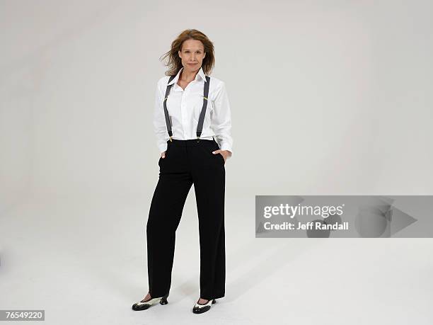mature woman wearing trousers and braces, smiling - women in suspenders stock pictures, royalty-free photos & images