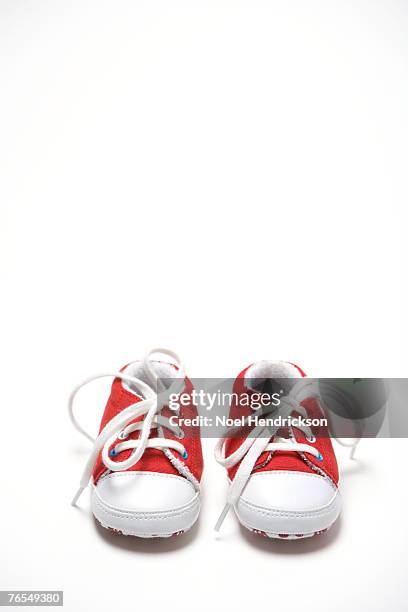 pair of red baby shoes - baby booties stock pictures, royalty-free photos & images
