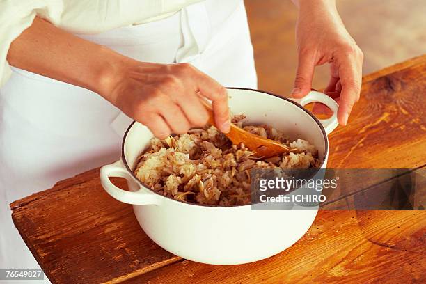 man stirring rice in pan, mid section - lohas stock pictures, royalty-free photos & images