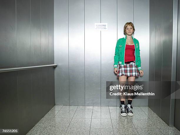 young woman standing in lift - ascensor interior fotografías e imágenes de stock