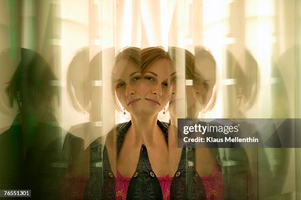 young woman reflected in glass panes - same stock pictures, royalty-free photos & images