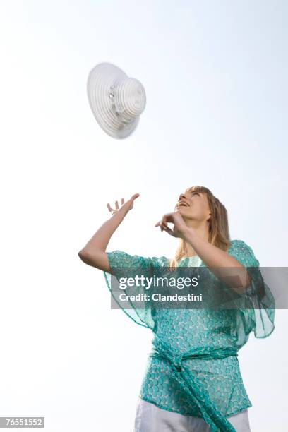 young woman throwing a hat - catching stock pictures, royalty-free photos & images
