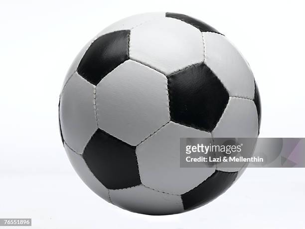 football against white background, close-up - fußball spielball stock-fotos und bilder
