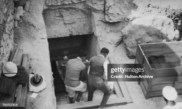Crates are brought out of the newly-discovered tomb of Tutankhamun in the Valley of the Kings, Luxor, circa 1923.