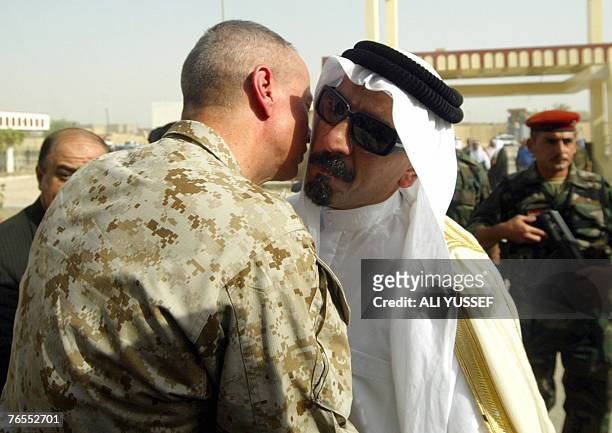 Iraqi tribal leader Sheikh Sattar Abu Risha is given a welcoming embrace by Brigadier General John Allen , Deputy Commander, U.S. Forces in Anbar...