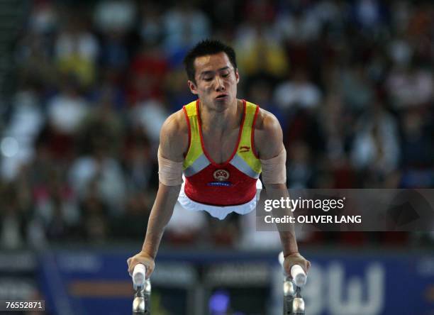 Qin Xiao of China competes on the parallel bars during the men's team final of the 40th World Artistic Gymnastics Championships 06 September 2007 at...