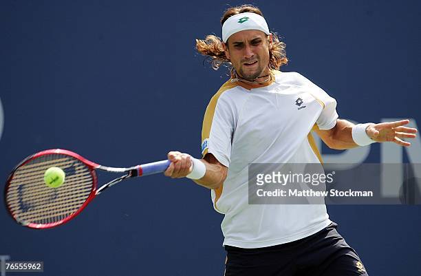 David Ferrer of Spain return a shot against Juan Ignacio Chela of Argentina during day eleven of the 2007 U.S. Open at the Billie Jean King National...