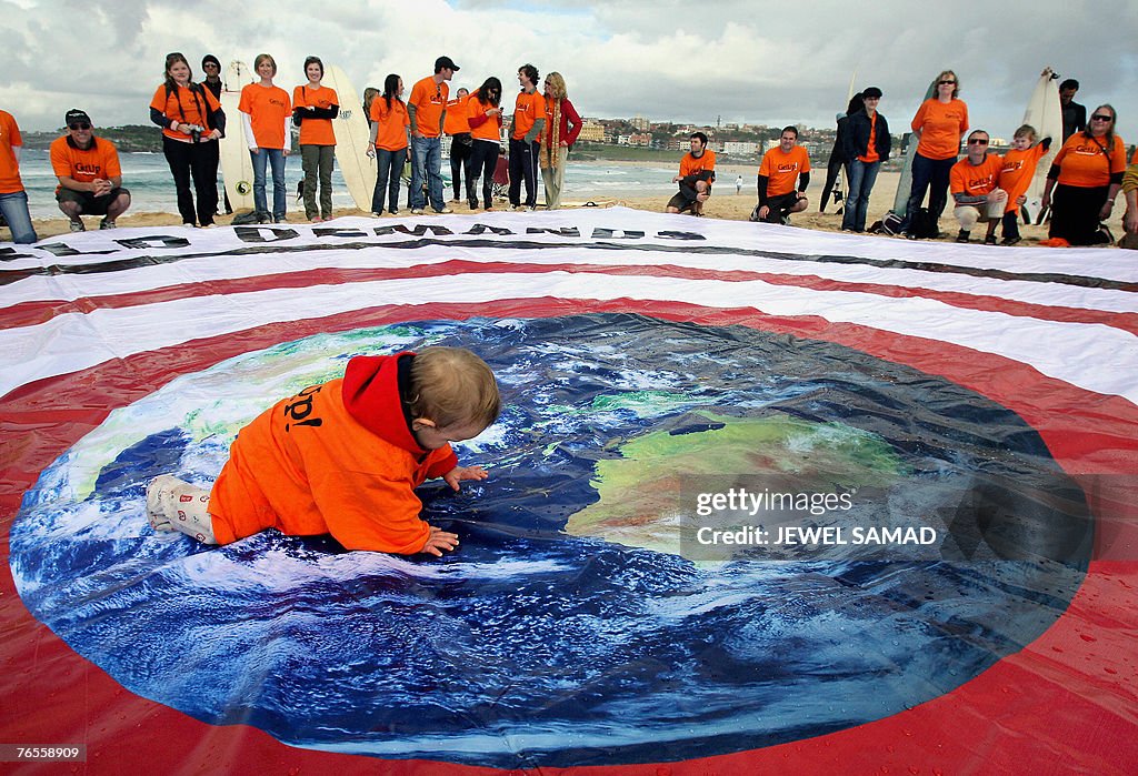 A child crawls across a huge banner as e