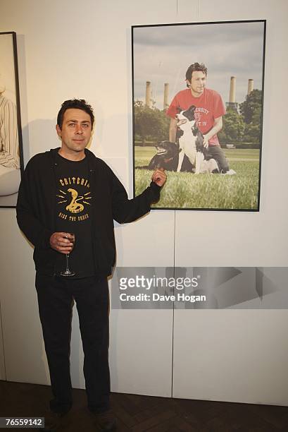 Comedian Sean Hughes poses infront of his calendar photograph with his crossbreed dogs Sweep and Betty at the Launch of the 2008 Pdsa Calendar...