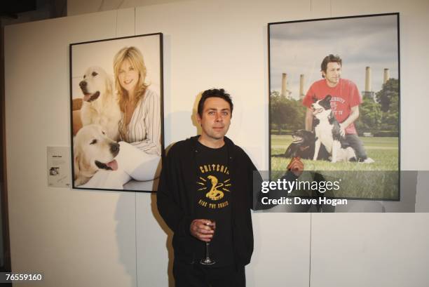 Comedian Sean Hughes poses infront of his calendar photograph with his crossbreed dogs Sweep and Betty at the Launch of the 2008 Pdsa Calendar...