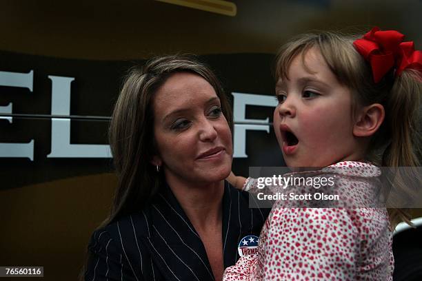 Jeri Thompson, with daughter Hayden, the wife of Actor and former U.S. Senator Fred Thompson listens to her husband make a speech during a campaign...