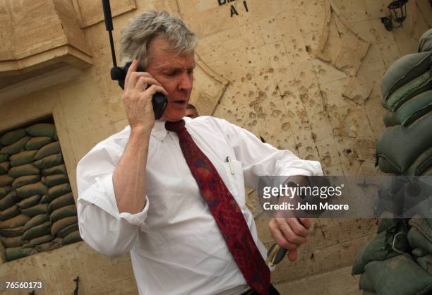 Ambassador to Iraq Ryan Crocker checks his watch just before leaving for Washington D.C. September 6, 2007 in Ramadi, Anbar Province, Iraq. Crocker...