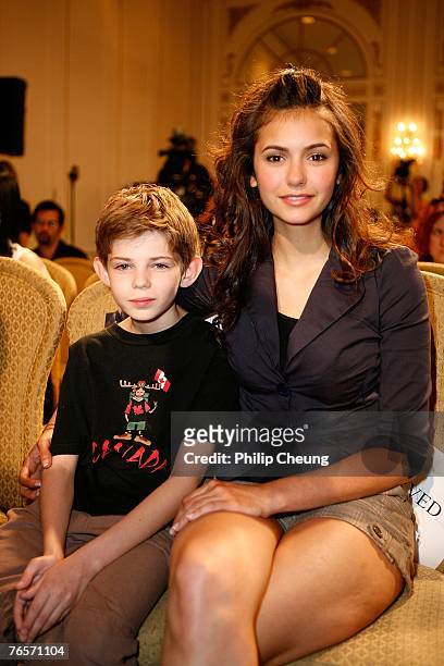 Actor Robbie Kay and actress Nina Dobrev wait for the start of the "Fugitive Pieces" press conference during the Toronto International Film Festival...