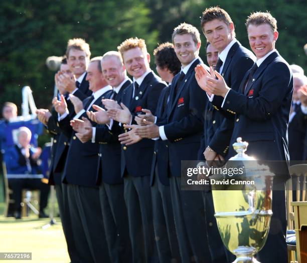 Lloyd Saltman of Scotland and of the Great Britain and Ireland team with Daniel Willett of England and the Walker Cup during the flag raising...
