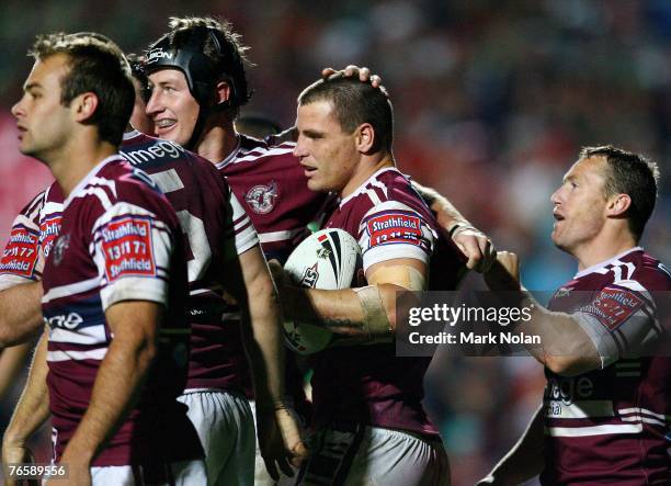 Anthony Watmough of the Eagles is congratulated after scoring during the NRL qualifying final match between the Manly Sea Eagles and the South Sydney...