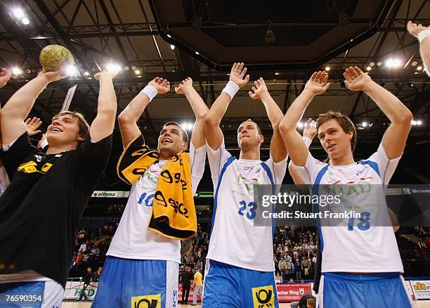 Michal Jurecki of Hamburg celebrates with Pascal Hens and Hans Lindberg after the Bundesliga Handball match between HSV Hamburg and TV Grosswallstadt...