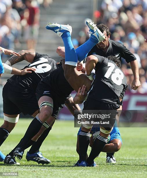 Manoa Vosawai of Italy is dumped by Sione Lauaki and Chris Masoe of New Zealand during Match Two of the Rugby World Cup 2007 between New Zealand and...