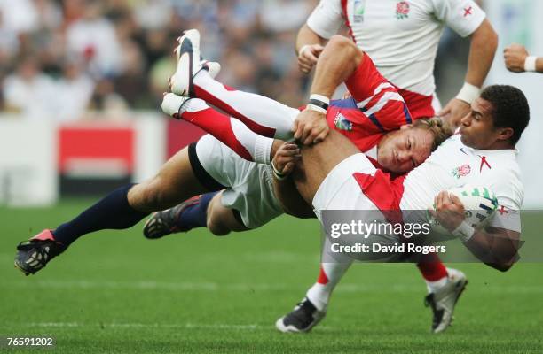 Jason Robinson of England is upended by Paul Emerick of the USA during the Rugby World Cup 2007 match between England and the USA at the Stade Felix...