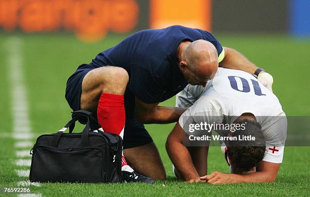 Olly Barkley of England receives treatment from England physio, Phil Pask after being upended by Paul Emerick of the USA during the Rugby World Cup...