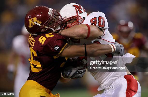 Tom Crabtree of the Miami of Ohio Redhawks makes a reception and is tackled by Steve Davis of the Minnesota Golden Gophers on September 8, 2007 at...