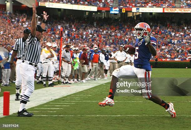 Wide receiver Andre Caldwell of the Florida Gators scores on a touchdown run in the second quarter against the Troy Trojans at Ben Hill Griffin...