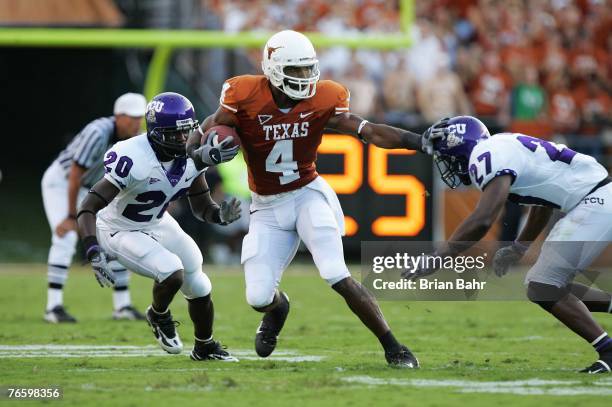 Wide receiver Limas Sweed of the Texas Longhorns fends off safety David Roach and cornerback Nick Sanders of the TCU Horned Frogs after making a...