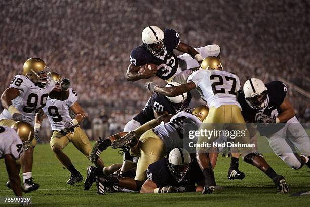 Austin Scott of the Penn State Nittany Lions leaps over the defense against the University of Notre Dame Fighting Irish at Beaver Stadium on...