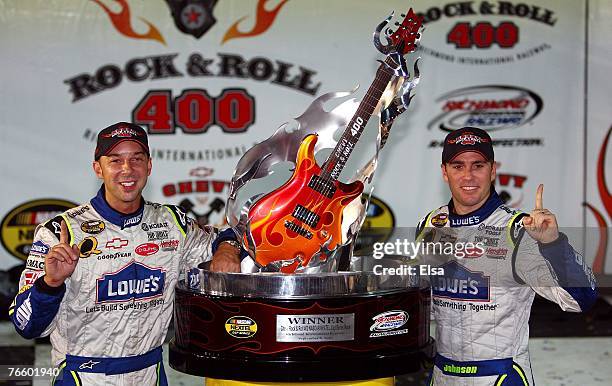 Jimmie Johnson, driver of the Lowe's Chevrolet, celebrates in victory lane with crew chief Chad Knaus, after winning the NASCAR Nextel Cup Series...