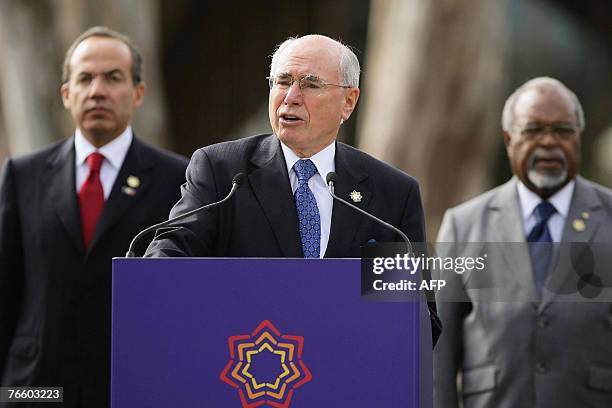 Mexican President Felipe Calderon and Papua New Guinea Prime Minister Michael Somare look on as Australian Prime Minister John Howard delivers the...