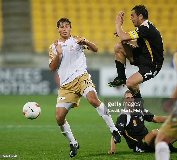 Phoenix captain Ross Aloisi jumps to deflect a high pass with Adam D'Apuzzo of the Jets during the round three A-League match between the Wellington...