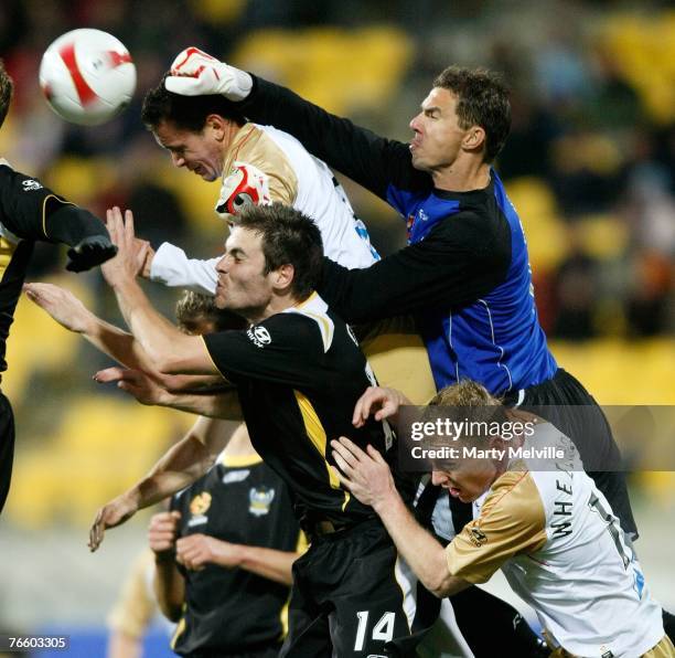 Jets keeper Ante Covic jumps to deflect a shot at goal with Steve O'Dor of the Phoenix during the round three A-League match between the Wellington...