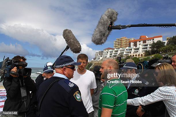 Police officers ask protesters to remove their banner from the beach during 'the spouses lunch' held at Bondi Icebergs restaurant September 9, 2007...