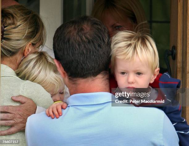 Gerry McCann arrives home carrying his son Sean as his wife Kate holds her daughter Amelie as she hugs a relative on September 9, 2007 in Rothley,...