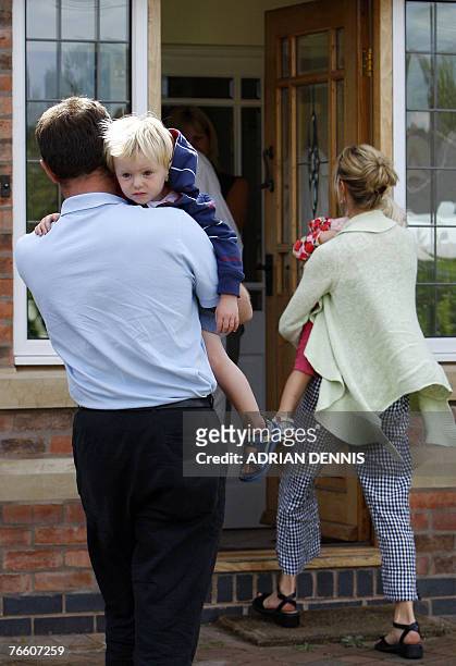 Gerry and Kate McCann carry their twins Amelie and Sean into the house after arriving back at the family home in Rothley, Leicestershire 09 September...