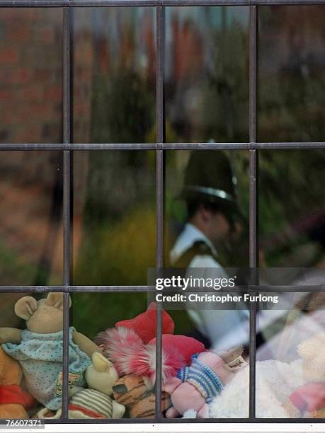 Policeman is reflected in the window of the home of Gerry and Kate McCann as they arrive back in the UK on September 9, 2007 in Rothley, England. The...