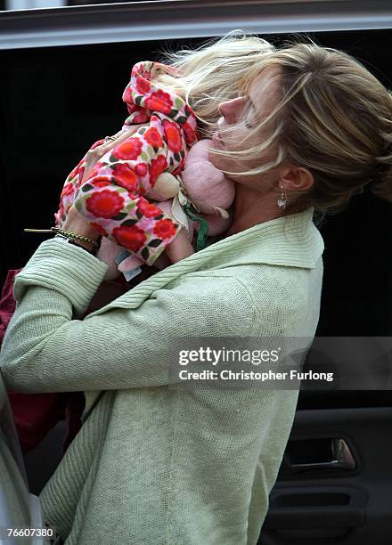 Kate McCann arrives home carrying her daughter Amelie on September 9, 2007 in Rothley, England. The McCann family have returned from Portugal after...