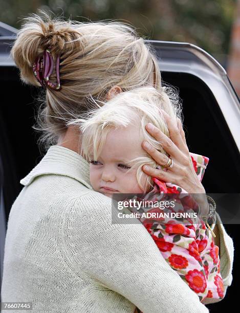 Kate McCann carries one of her twins Amelie into the house after arriving back at the family home in Rothley, Leicestershire 09 September 2007. The...