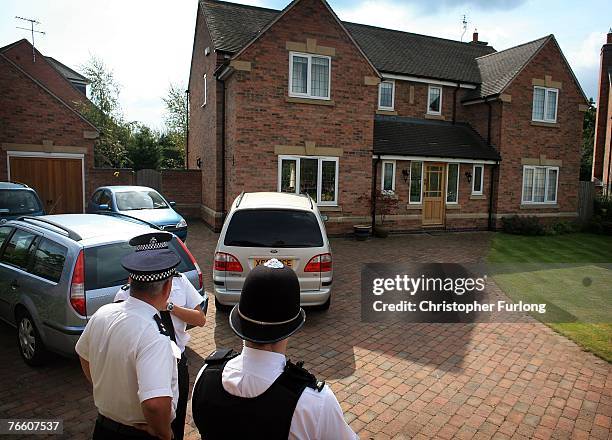 Police stand guard outside the home of Gerry and Kate McCann after their arrival on September 9, 2007 in Rothley, England. The McCann family have...