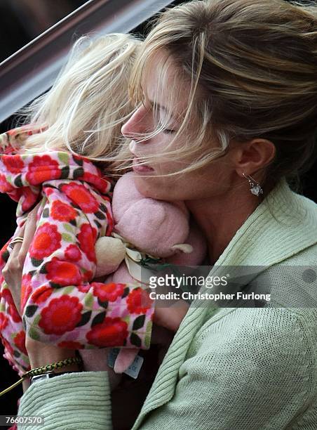 Kate McCann arrives home carrying her daughter Amelie on September 9, 2007 in Rothley, England. The McCann family have returned from Portugal after...