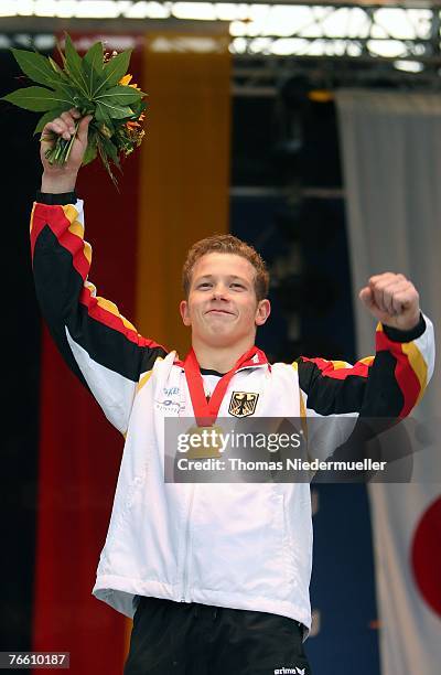 Fabian Hambuechen of Germany presents his gold medal after winning the apparatus final on the horizontal bar of the 40th World Artistic Gymnastics...