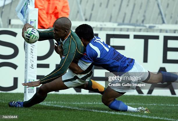 Pietersen of South Africa scores past David Lemi of Samoa during the IRB World Cup match between South Africa and Samoa on September 9, 2007 at Parc...