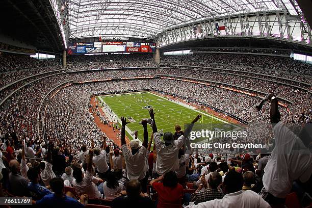 Fans celebrate as Andre Johnson of the Houston Texans scores a touchdown against the Kansas City Chiefs at Reliant Stadium September 9, 2007 in...