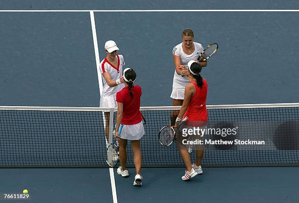 Nathalie Dechy of France and Dinara Safina of Russia are congratulated at the net by Yung-Jan Chan and Chia-Jung Chuang of Chinese Taipei after Dechy...