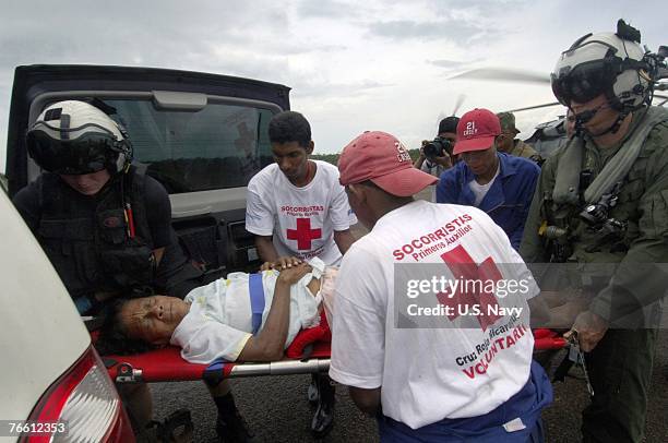 In this handout provided by the U.S. Navy, a woman injured during Hurricane Felix is moved by Nicaraguan Red Cross volunteers from a USS Wasp...