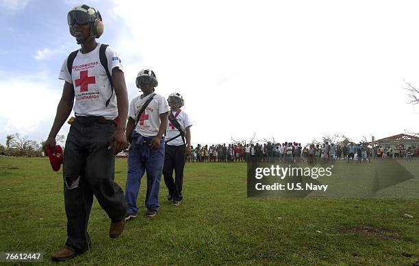 In this handout provided by the U.S. Navy, Red Cross volunteers participating in Hurricane Felix disaster relief operations prepare to distribute...