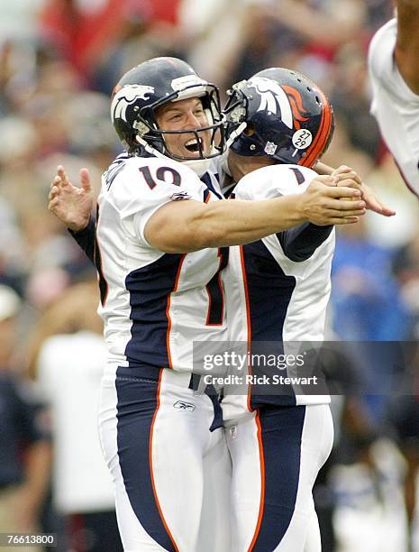 Todd Sauerbrun and Jason Elam of the Denver Broncos celebrate Elam's 42 yard game winning field goal with 0:00 time left against the Buffalo Bills at...