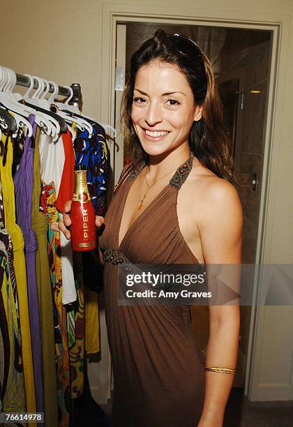 Actress Emmanuelle Vaugier holds a bottle of Piper Heidsieck champagne at the Star Lounge In Honor of Rolling Stone's 40th Anniversary at the Hard...